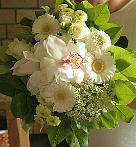 Wedding gift flowers arrangement made of  germini, cymbidium orchid, roses, santini, freesia, etc.